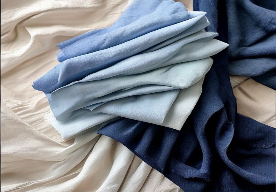 Indigo-dyed silk and linen stoles in a gradient of blues